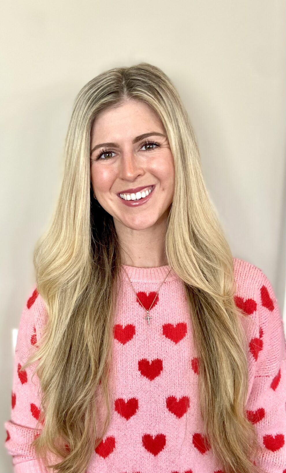 A blonde-haired woman smiles at the camera.