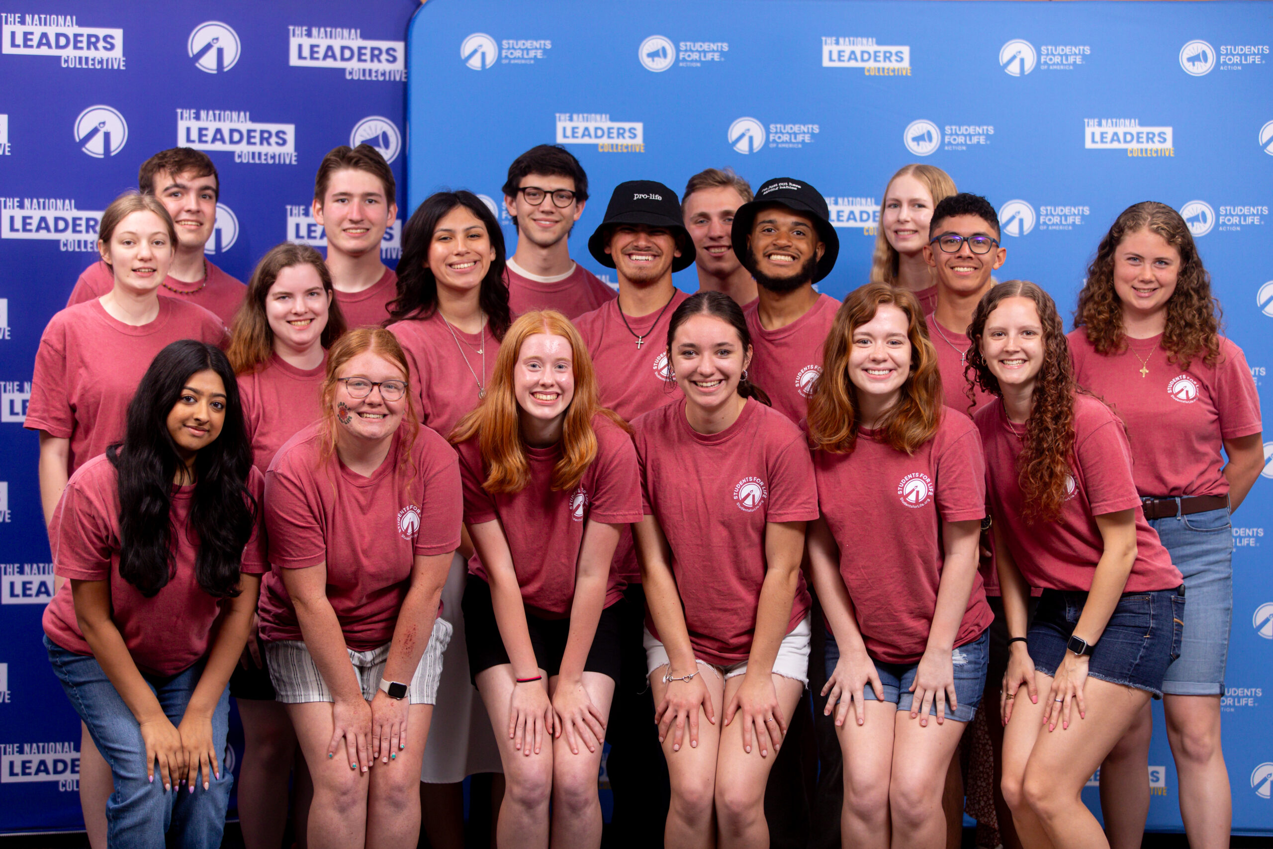 A group photo. The people in the front row are leaning over slightly with their hands on their thighs.