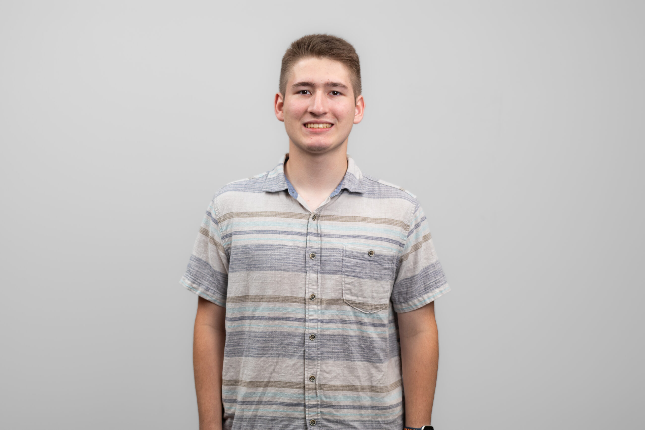 A man smiles at the camera.
